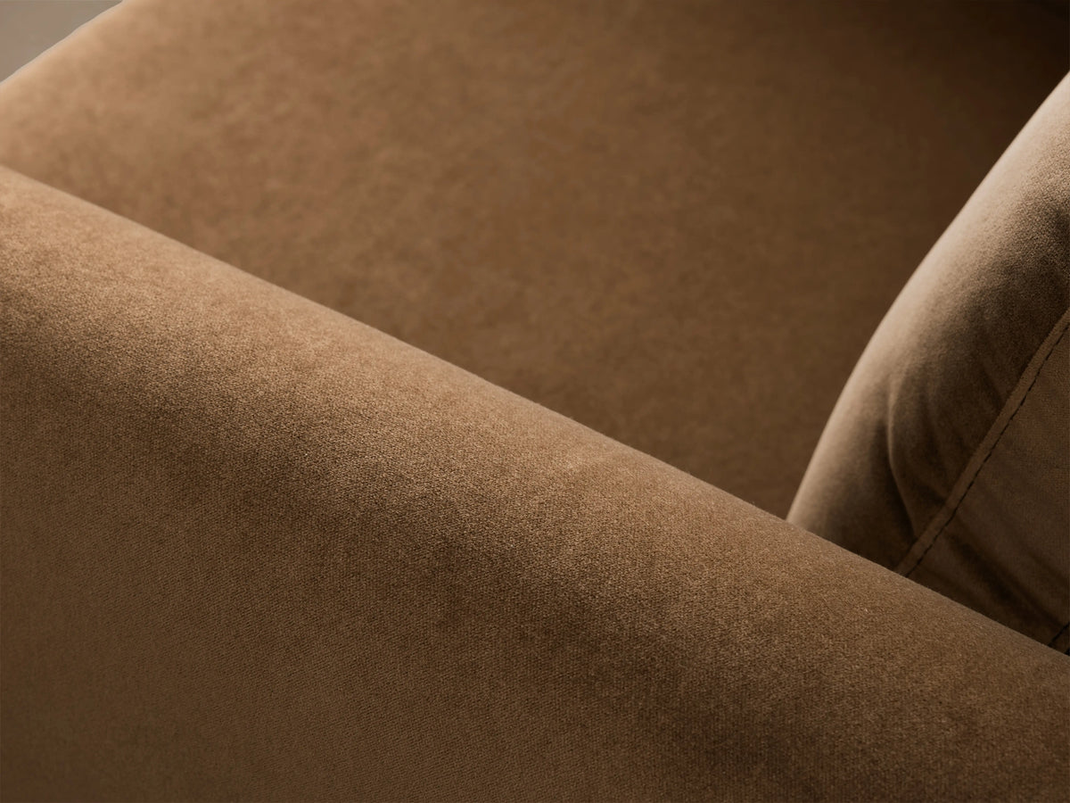 Close-up of Fontana Swivel Chair's camel brown armrest and cushion in soft, textured fabric with visible stitching.