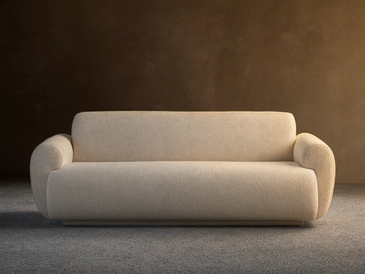 Gianni Sofa, modern cream textured fabric sofa with rounded arms and base, on a hardwood floor against a light wall.