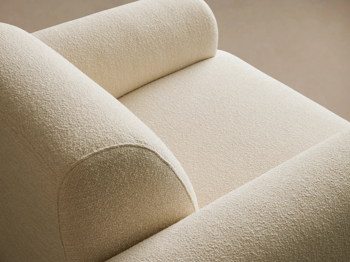 Front view of Gianni Swivel Chair. Light beige, textured, plush upholstery with curved arms and back. Sits on wood floor.