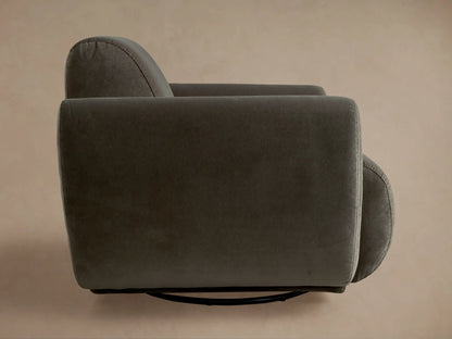 Dark gray plush Gianni Swivel Chair, viewed from the back-left, featuring a tall backrest and thick, rounded armrests.