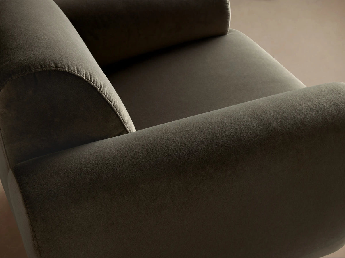 Side profile of a plush charcoal grey Gianni Swivel Chair, showing its rounded backrest, square base, and black swivel mechanism.