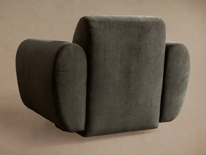 Close-up of a dark gray Gianni Swivel Chair in soft, plush fabric, highlighting its curved armrest and backrest detail.