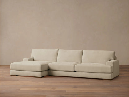 Norwalk Two-Piece Chaise Sectional in beige fabric, featuring a left-facing chaise and three-seat sofa on wooden floor, against a neutral wall.