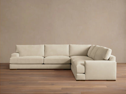 Norwalk Three-Piece Corner Sectional in a neutral tone, featuring plush cushions and a clean, simple design on a wooden floor.