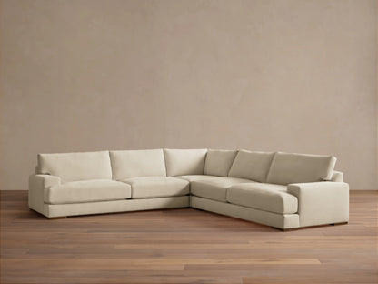 Norwalk Three-Piece Corner Sectional in a neutral tone, featuring plush cushions and a clean, simple design on a wooden floor.