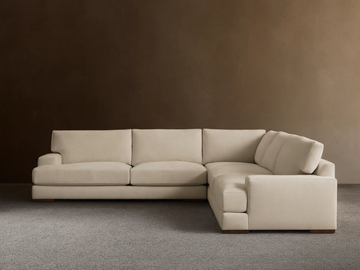 Norwalk Three-Piece Corner Sectional in a neutral tone, featuring plush cushions and a clean, simple design on a wooden floor.