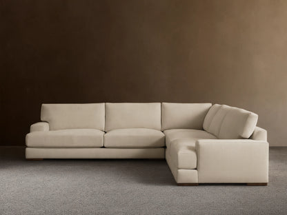 Norwalk Three-Piece Corner Sectional in a neutral tone, featuring plush cushions and a clean, simple design on a wooden floor.