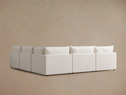 Alt text: Close-up of Owen Five-Piece Corner Sectional in beige fabric, showing soft cushions and angled armrest, emphasizing comfort and craftsmanship.