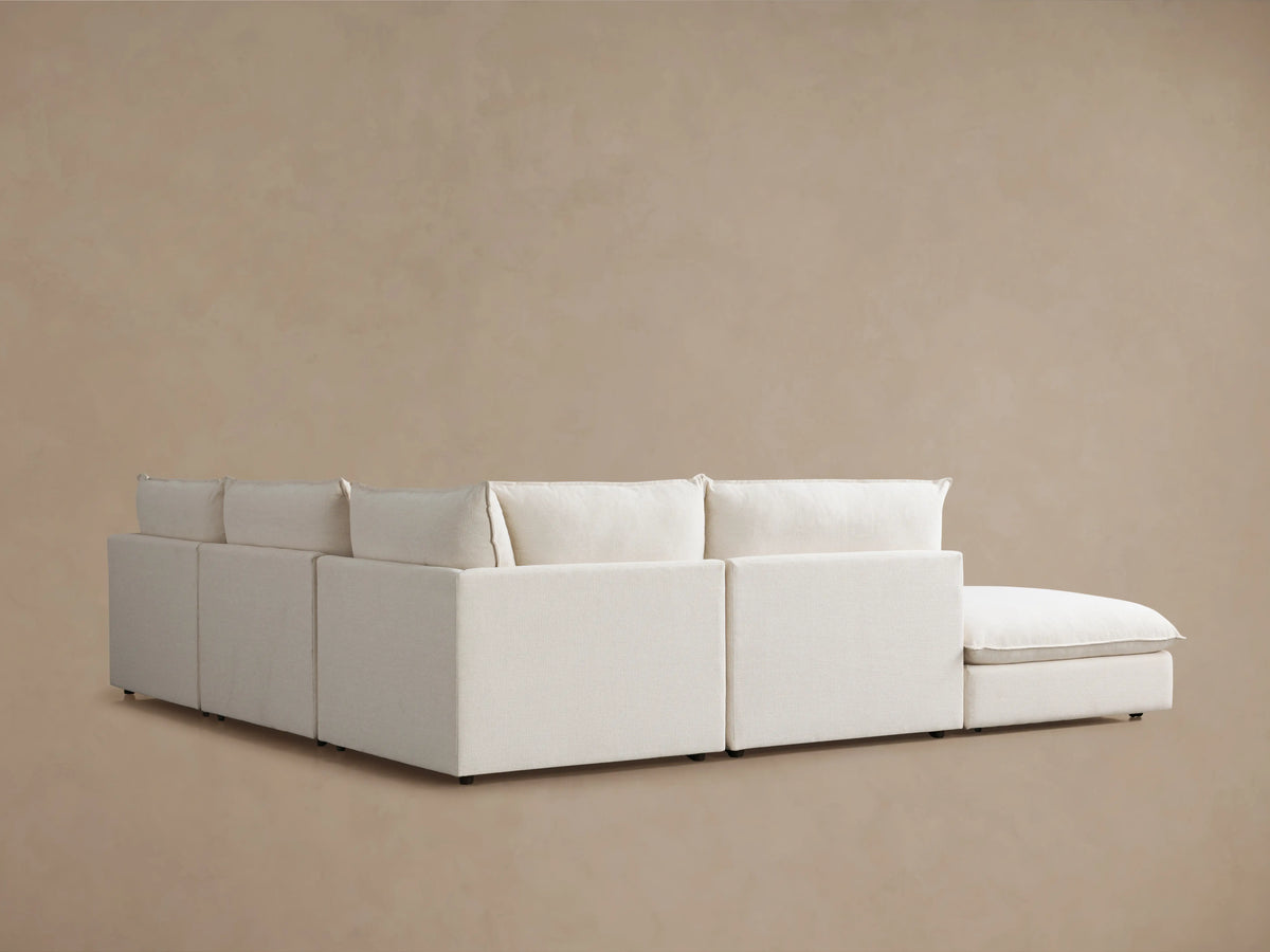 Cream-colored Owen Five-Piece Sectional close-up showing soft, plush seat and back cushions with smooth, clean lines.