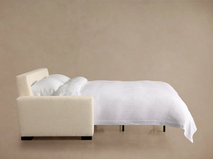 Beige Remington Luxury Sleeper Sofa unfolding, showing its white mattress and black pull-out mechanism.
