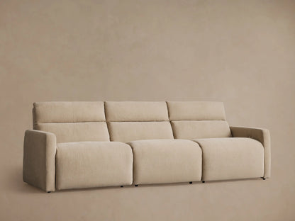 Rowland tailored three-piece motion modular sofa, light beige. Straight-on view on wood floor against light wall.