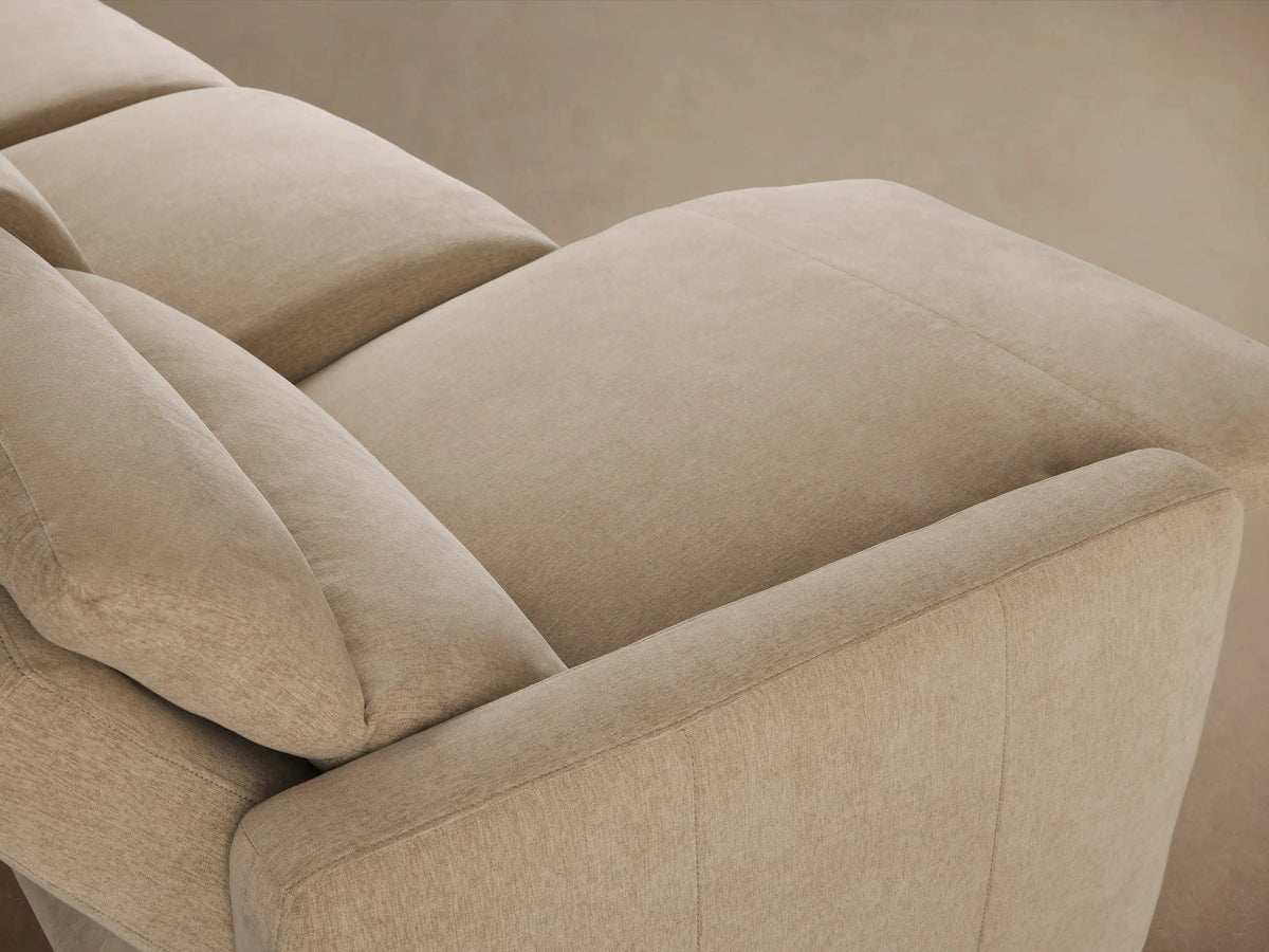 Close-up of Rowland Modular Sofa's textured beige fabric with two circular metallic power recline control buttons.