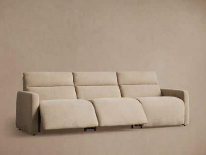 Close-up, high-angle view of a Rowland Three-Piece Modular Sofa in a light tan, woven fabric, showing plush cushions and an armrest.