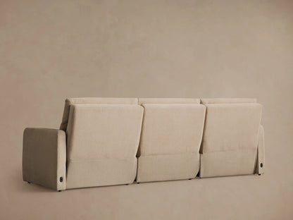 Rowland Tailored Three-Piece Motion Modular Sofa in beige, with the rightmost recliner seat fully extended on a neutral wall.