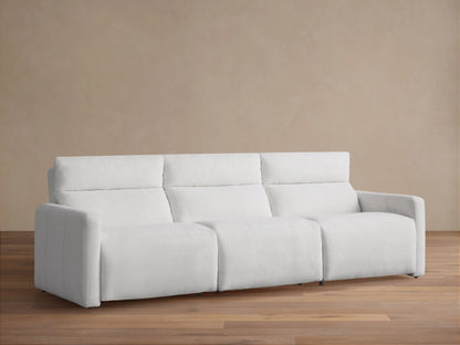 Front view of a white Rowland Tailored Three-Piece Motion Modular Sofa on a wood floor, against a beige wall. Plush, tailored fabric.