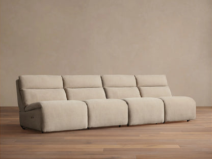 Light beige Rowland Tailored 4-piece armless modular sofa, seen straight-on against a beige wall with a wooden floor.