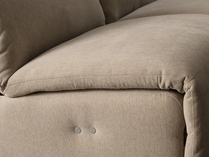 Close-up of Rowland Tailored Sofa's textured beige fabric with two brushed silver, circular metal buttons.