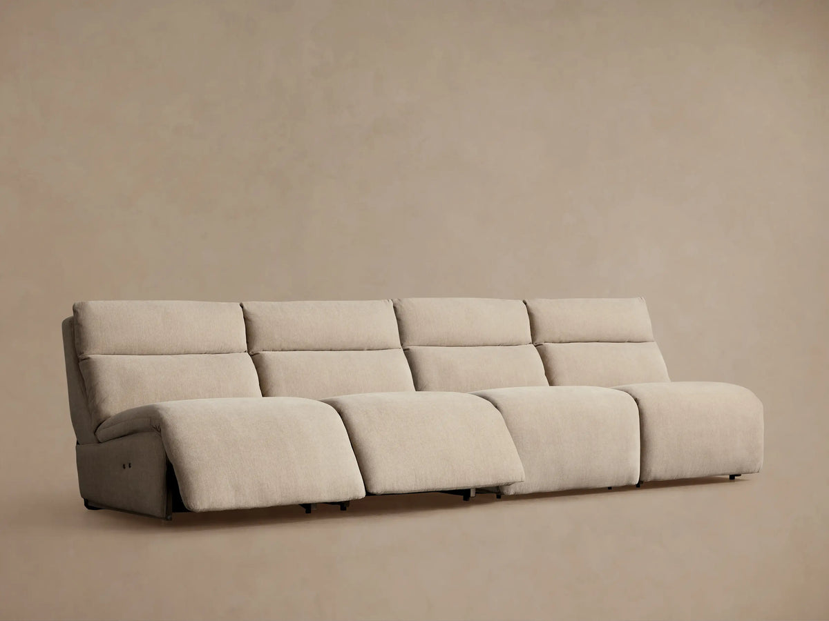 Close-up of Rowland Tailored Modular Sofa's light beige upholstered seat cushion, backrest, and two silver buttons.