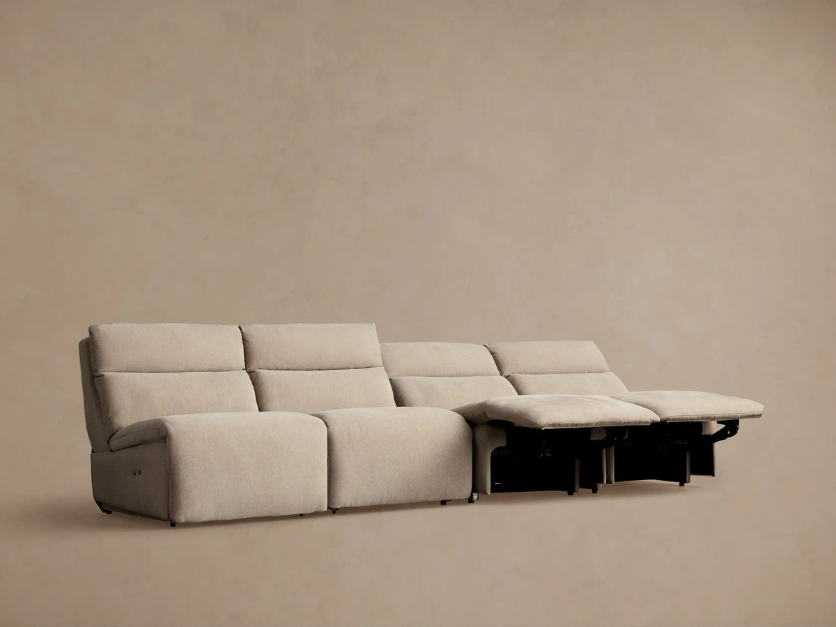 Light beige Rowland Tailored 4-piece armless motion modular sofa with footrests slightly extended, on a neutral background.