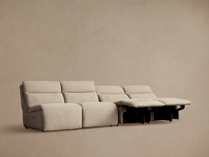 Light beige Rowland Tailored 4-piece armless motion modular sofa with footrests slightly extended, on a neutral background.