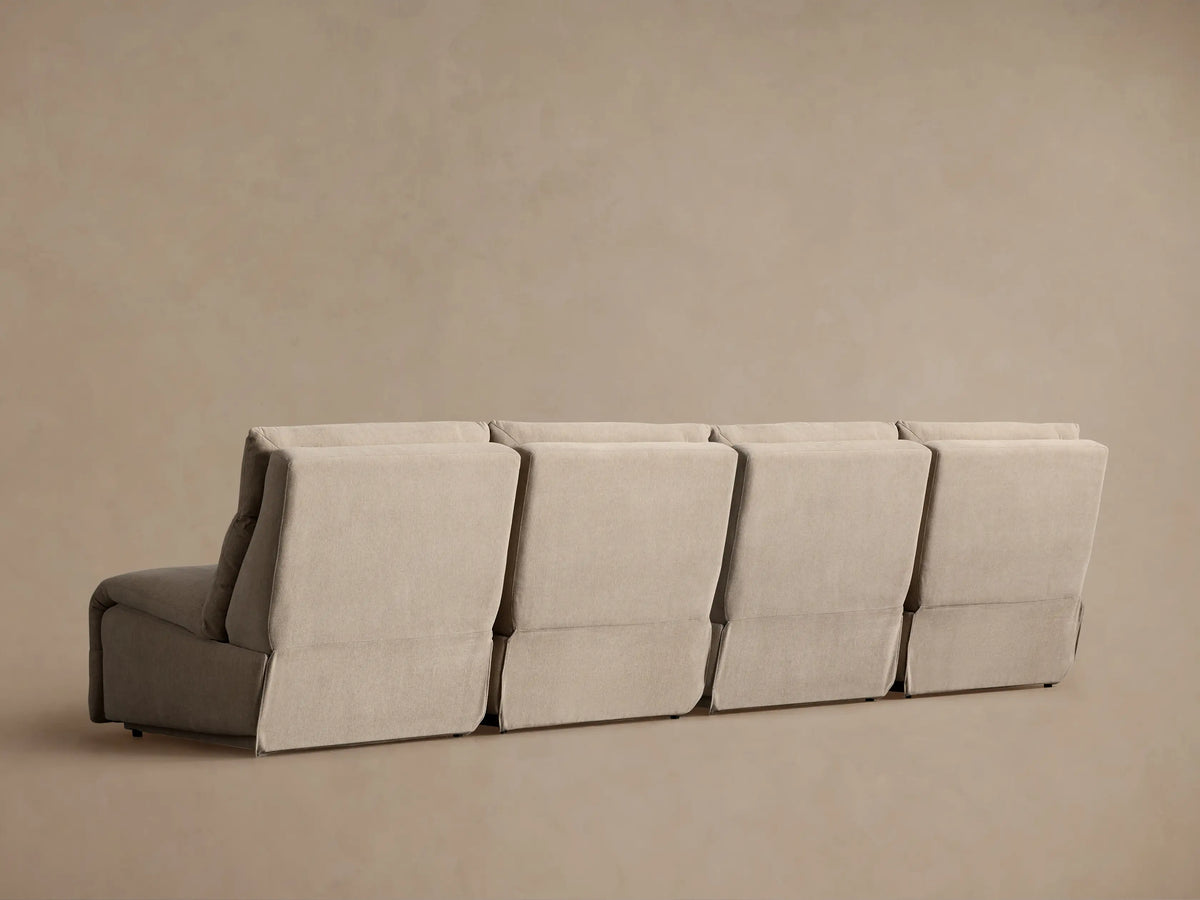 Rowland Tailored Four-Piece Armless Motion Modular Sofa in light beige, two sections reclined with footrests extended.