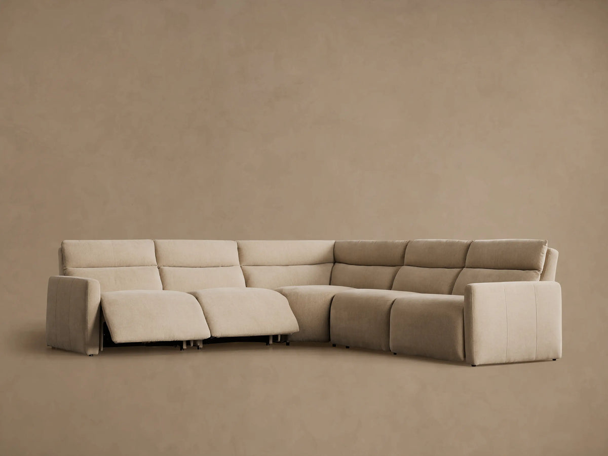 Close-up of a Rowland Tailored Five-Piece Motion Corner Sectional in light tan, showing an extended recliner footrest.