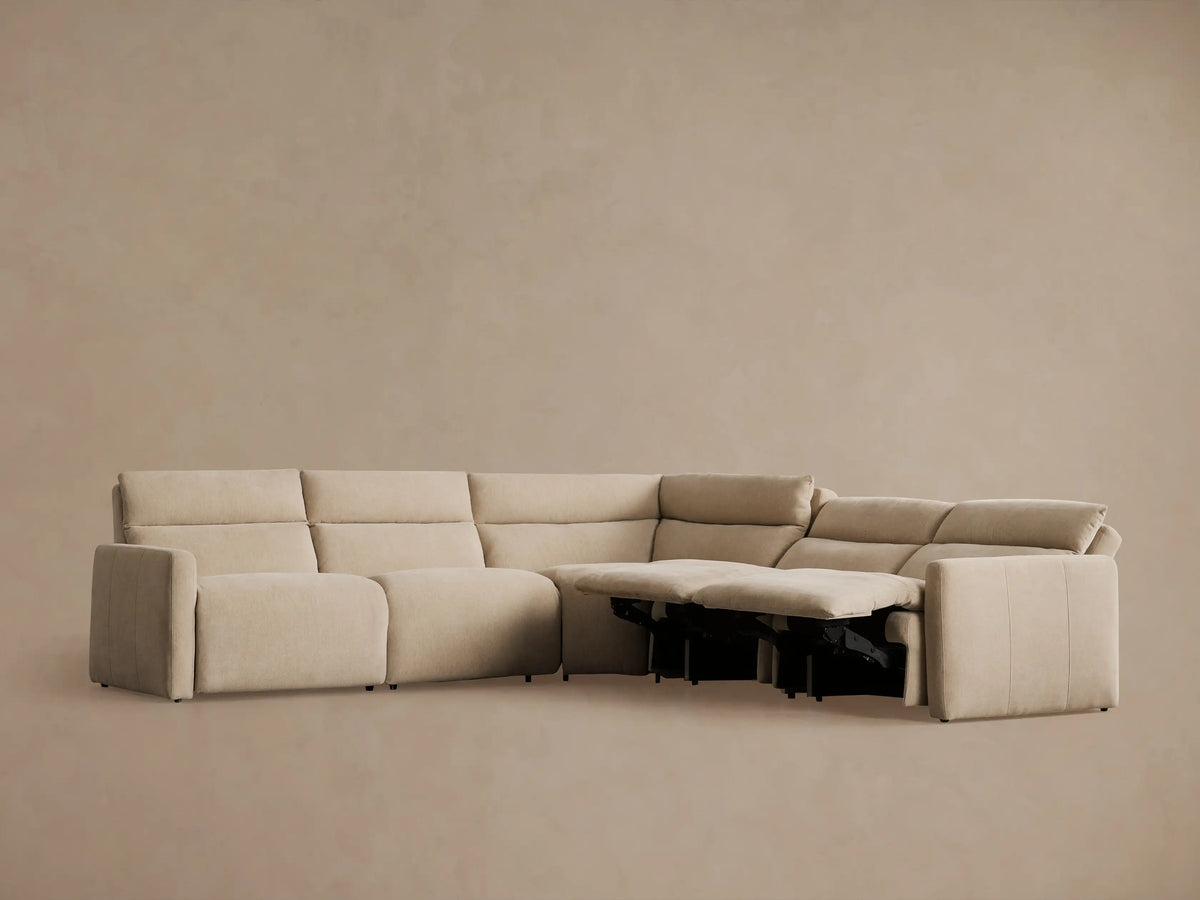 Rowland Tailored Five-Piece Motion Corner Sectional in beige fabric, two left recliners with footrests extended, studio shot.