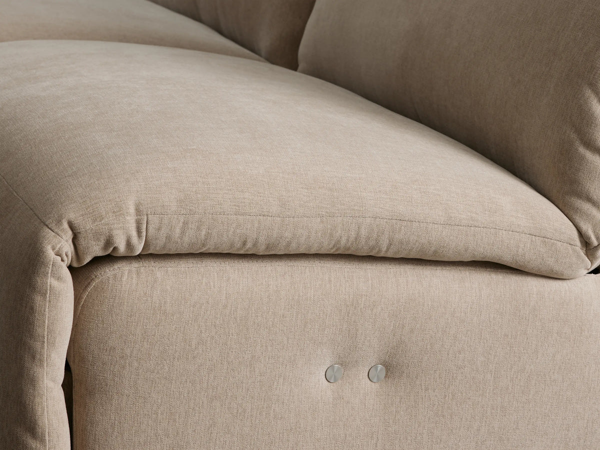Close-up of beige Rowland Tailored Six-Piece Motion Sectional with an extended footrest, showcasing its reclining mechanism.