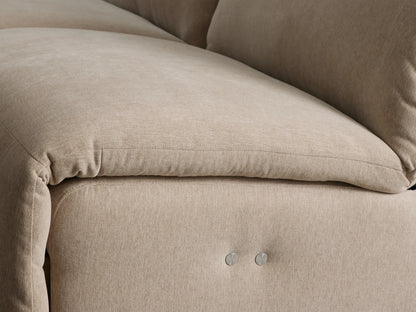 Close-up of beige Rowland Tailored Six-Piece Motion Sectional with an extended footrest, showcasing its reclining mechanism.