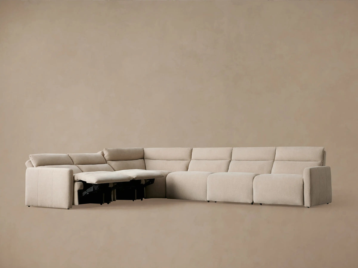 Light beige Rowland Tailored Six-Piece Motion Sectional, L-shaped, with footrests extended on several reclining seats.