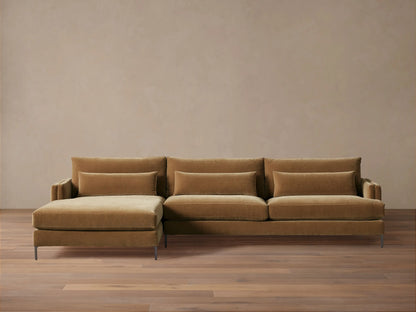 Front view of a golden-brown velvet Sumner Two-Piece Chaise Sectional with a left-facing chaise and three lumbar pillows.