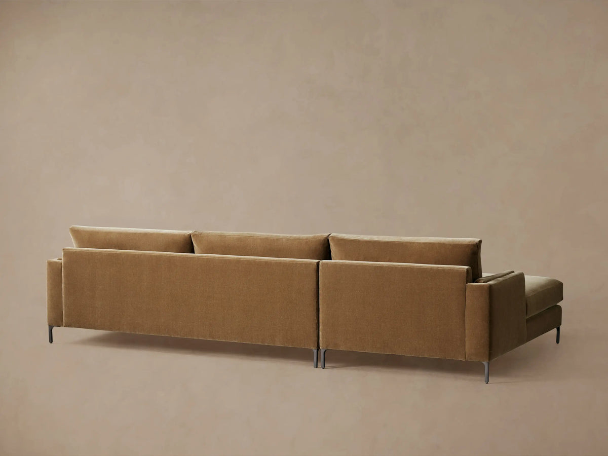 Close-up of the brown plush Sumner Two-Piece Chaise Sectional, showing the chaise, armrest, backrest, and lumbar toss pillow.