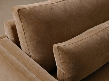 Brown Sumner Three-Piece Corner Sectional with clean lines and low backrests against a neutral wall, placed on hardwood floor.