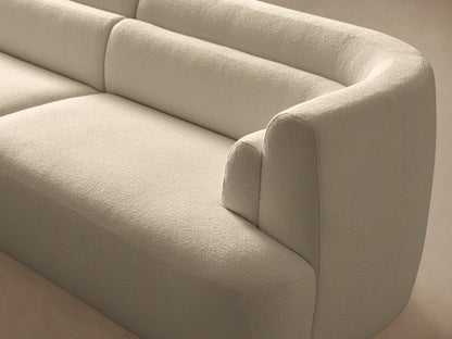 Lovina 3-piece sectional in light cream fabric. Left bumper chaise, armless chair, and right arm chair. Modern, on wood floor.