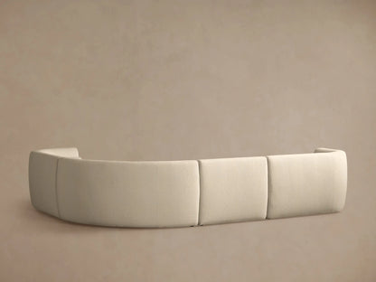 Close-up of curved Lovina Four-Piece Sectional. Light beige textured fabric, showing plush seat and back cushions.