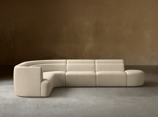 Lovina Five-Piece Sectional: cream textured L-shaped sofa with curved arm, straight sections, & ottoman on wood floor.