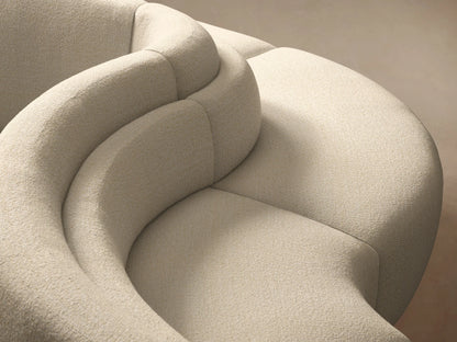 Cream Lovina Five-Piece Sectional, gracefully curved, modular and low-profile, on a wooden floor against a neutral wall.