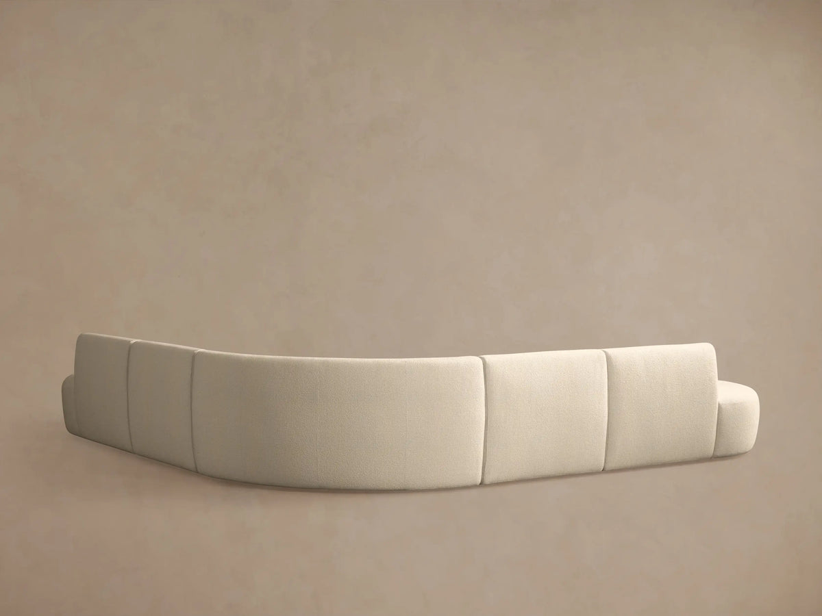 Close-up of Lovina Five-Piece Corner Sectional in light beige textured fabric, showing its curved design.