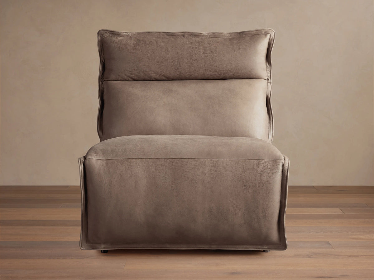 Rowland Leather High-Back Armless Motion Recliner in taupe leather, front view, against a light wall and wood floor.