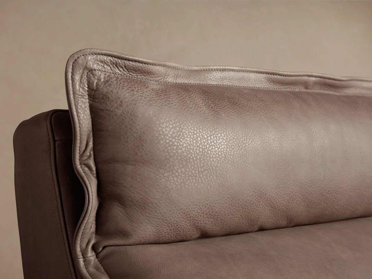 Rowland Leather High-Back Armless Motion Recliner in taupe leather, front view, against a light wall and wood floor.