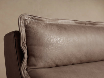 Rowland Leather High-Back Armless Motion Recliner in taupe leather, front view, against a light wall and wood floor.