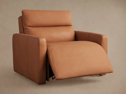 Close-up of Rowland Tailored Recliner's tan leather upholstery with two brushed silver buttons and stitched tufting.