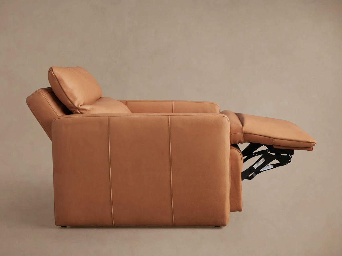 Rowland Tailored high-back motion recliner in camel leather, partially reclined with extended footrest.