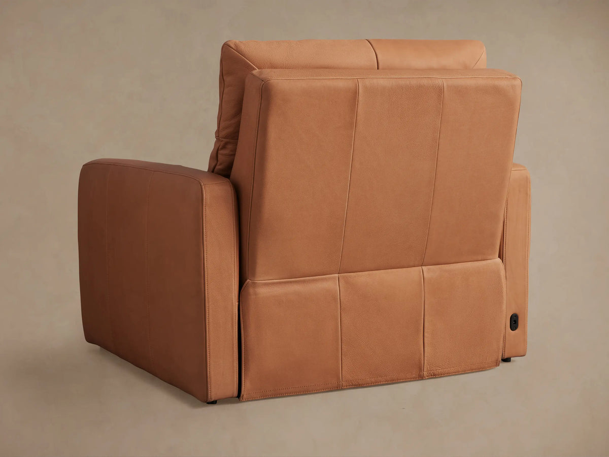 Side view of Rowland Tailored Leather High-Back Motion Recliner in warm tan, partially reclined with footrest extended.