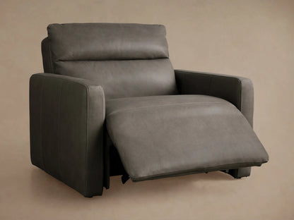 Rowland Tailored Leather Recliner: Close-up of textured grey leather with tufting, two shiny silver buttons, and vertical seam.