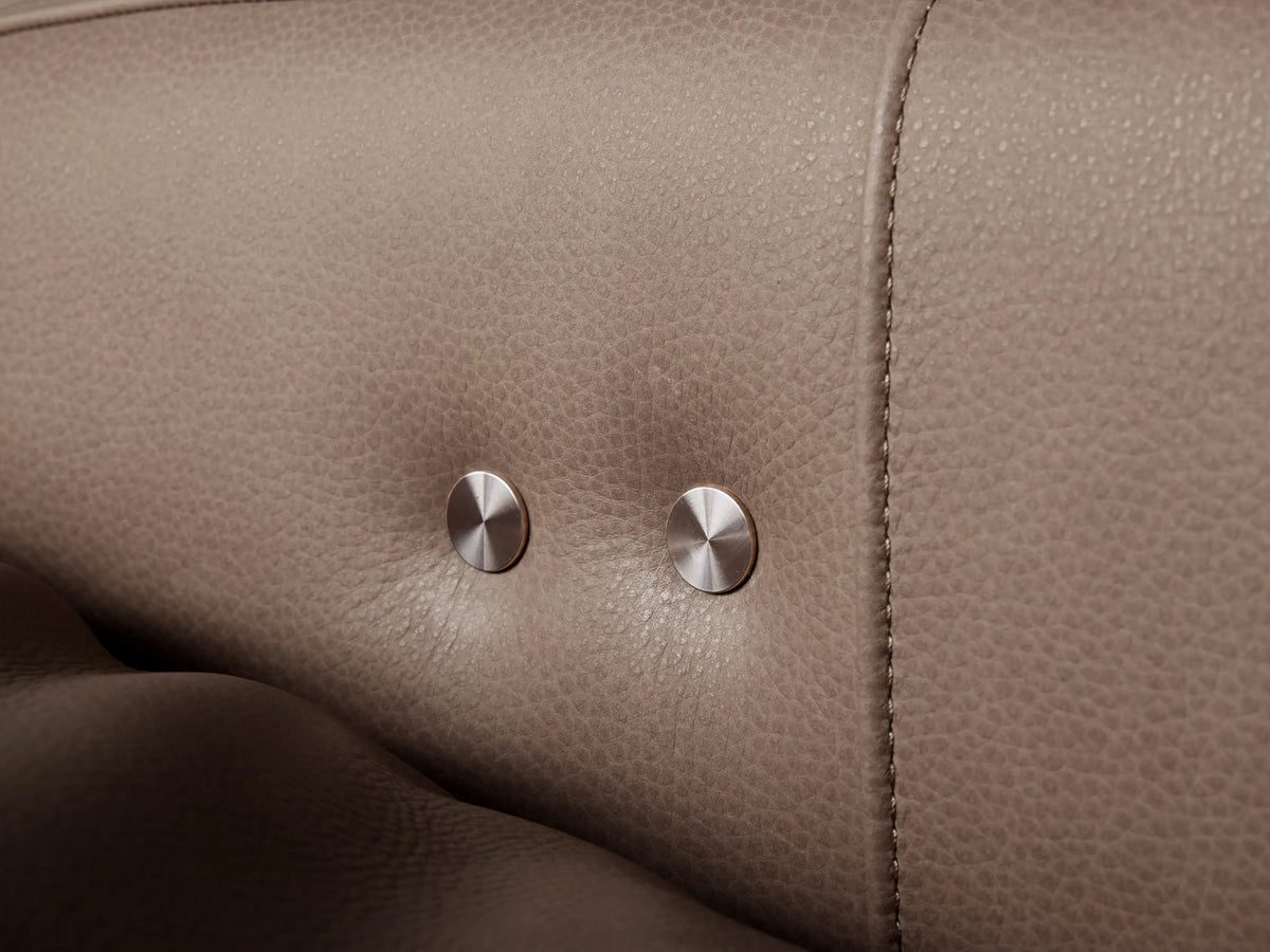Frontal view of Rowland Tailored Leather High-Back Motion Recliner in light taupe, with sleek arms & prominent stitching.
