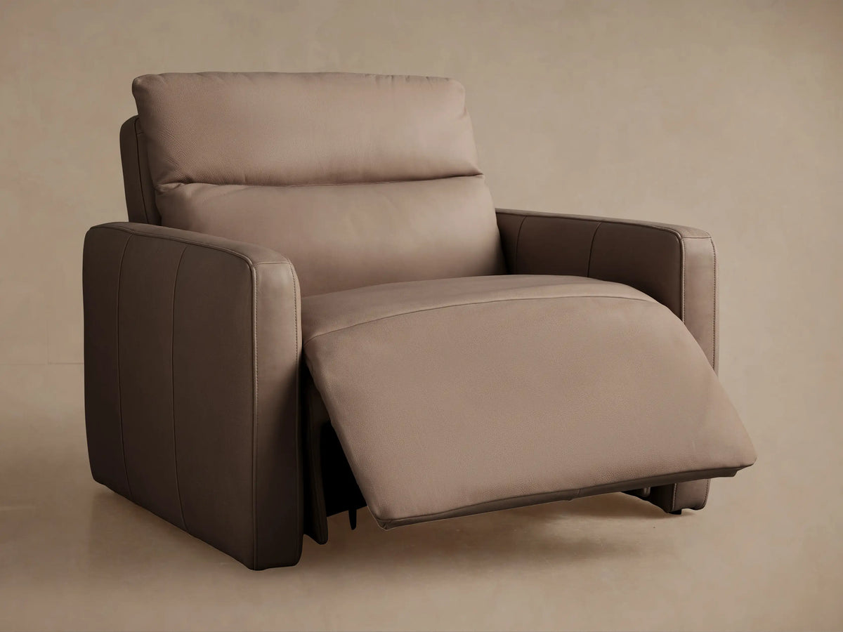 Close-up of Rowland Tailored Leather Recliner's plush taupe leather upholstery, highlighting soft texture & seam.
