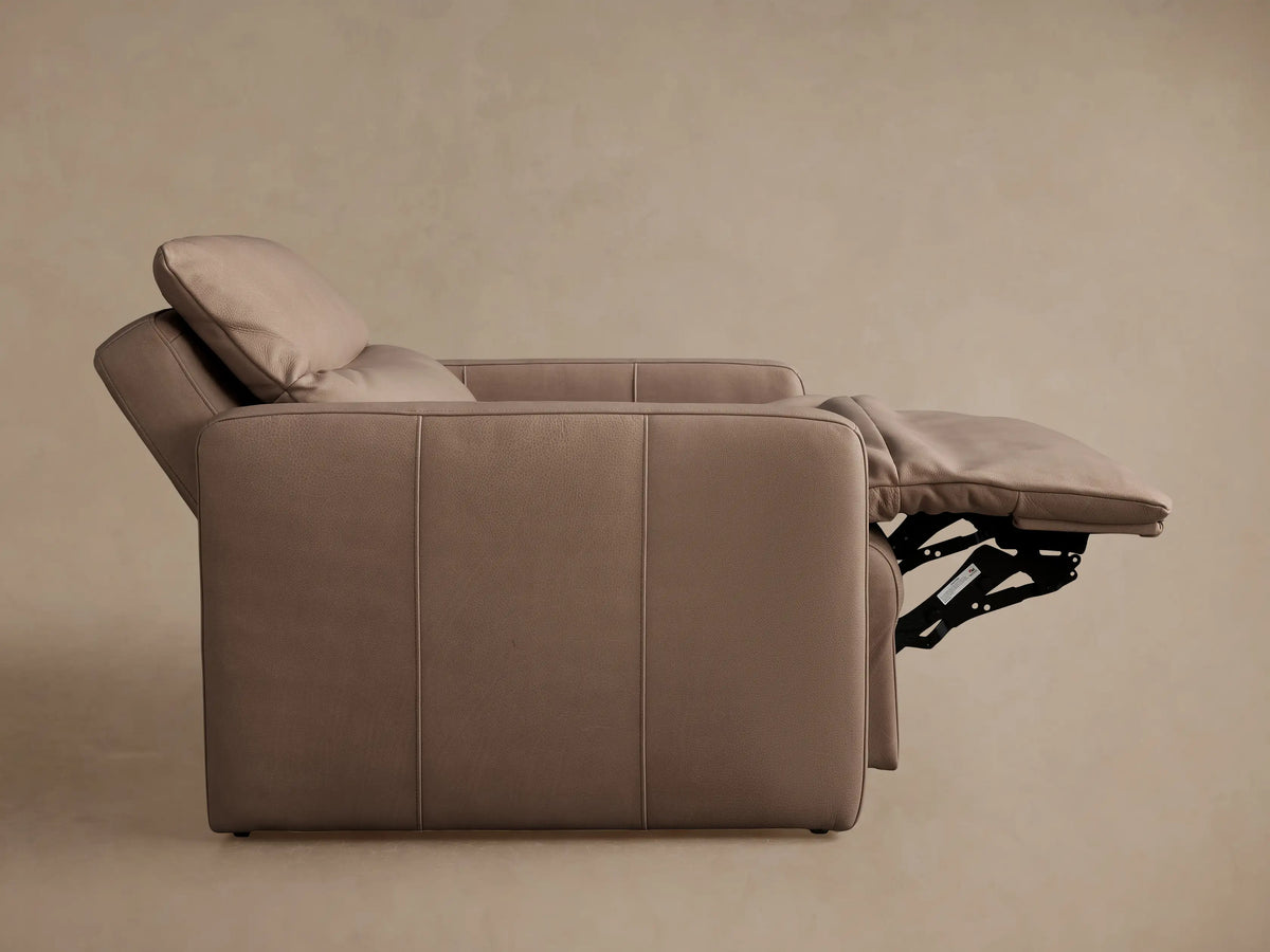 Rowland Tailored high-back motion recliner in two-tone taupe leather, reclined with extended footrest, front-right view.