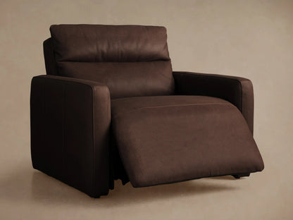 Close-up of Rowland Tailored Leather Recliner with textured brown leather upholstery, two round silver buttons, and stitching.