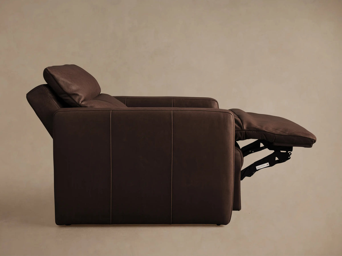 Rowland Tailored Leather High-Back Motion Recliner in dark brown, with extended footrest, shown angled.